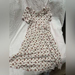 A flower dress. It’s white, there are pink detailed flowers and leaves on them.